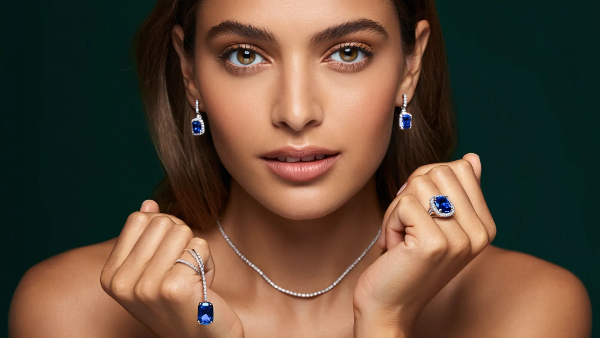 Woman showcasing elegant blue gemstone jewelry.
