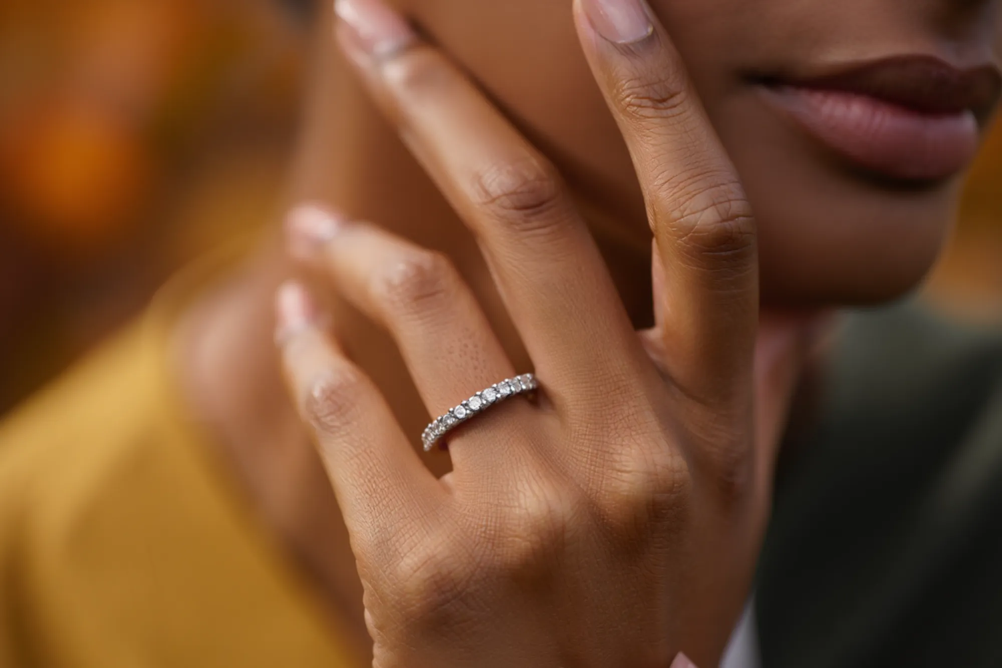 Close-up of a hand with a diamond ring.